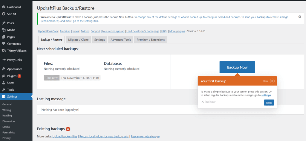 The settings page of the Updraft Plus plugin in the WordPress admin. You can see options to backup/restore, migrate/clone, settings, advanced tools, premium/extensions. There is also an orange pop out box prompting you to complete your first backup.